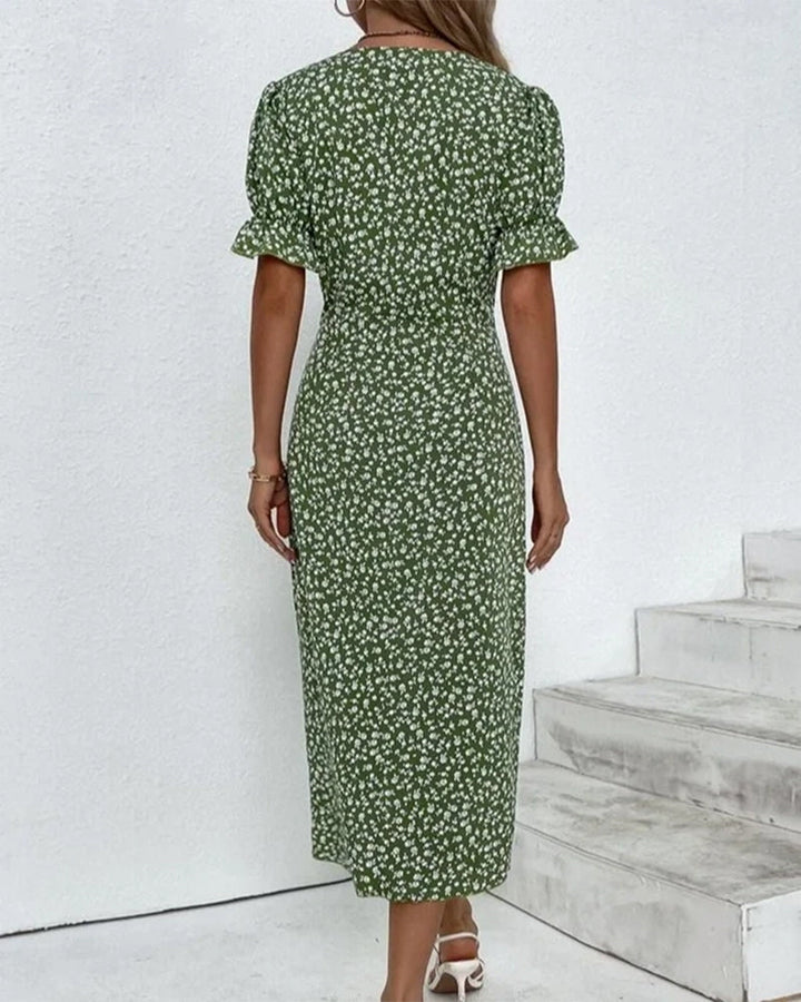 Green v-neck midi dress with white floral print, short puff sleeves, button details at back
