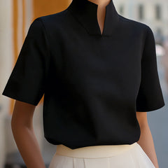Black structured blouse with stand collar and short sleeves, smooth minimalist front