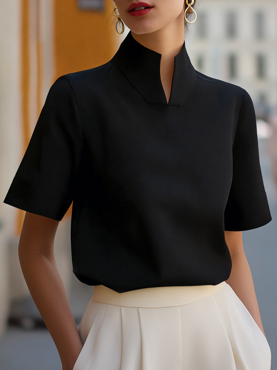 Black structured blouse with stand collar and short sleeves, smooth minimalist front