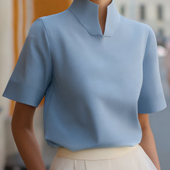 Light blue structured blouse with stand collar and short sleeves, clean minimalist front