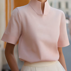 Blush pink structured blouse with stand collar and short sleeves, smooth minimalist front
