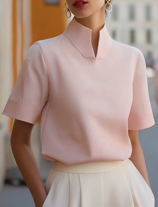 Blush pink structured blouse with stand collar and short sleeves, smooth minimalist front