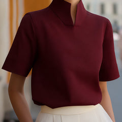 Burgundy structured blouse with stand collar and short sleeves, smooth minimalist front