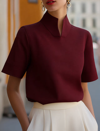 Burgundy structured blouse with stand collar and short sleeves, smooth minimalist front