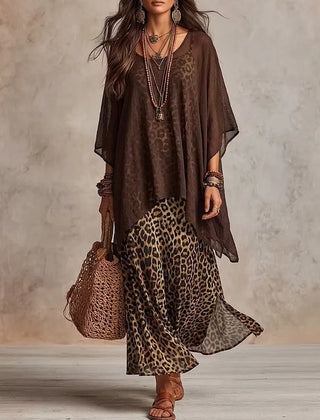 Brown bohemian maxi dress with leopard print skirt, sheer cape sleeves, tiered hem