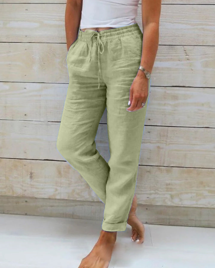 Light green cotton trousers with drawstring waist and tapered leg cuffs