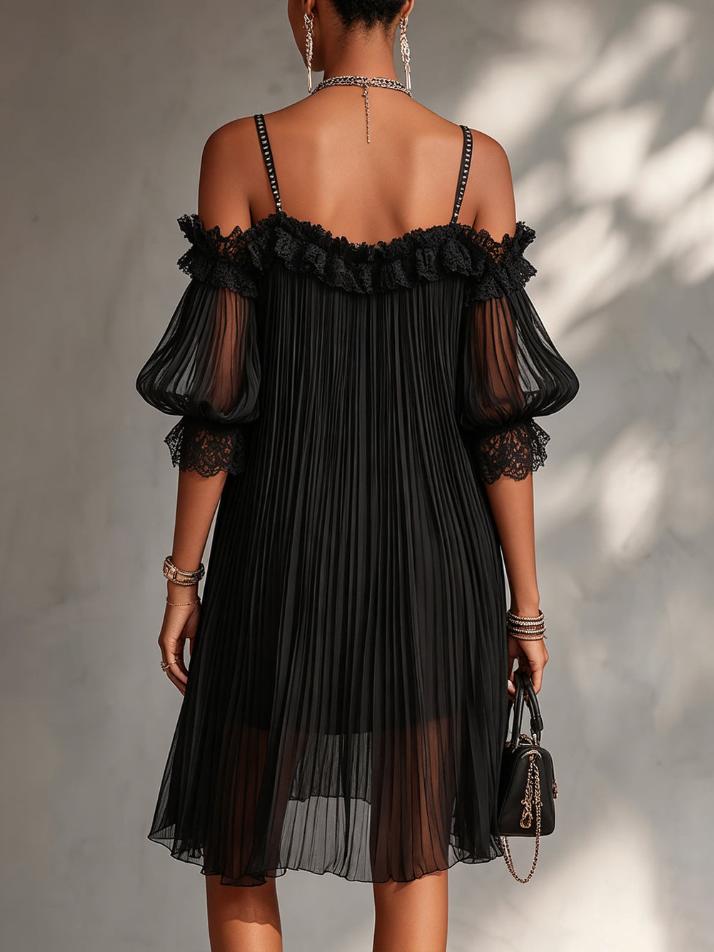 Black off-shoulder lace dress with open back, lace trim, and pleated tulle skirt