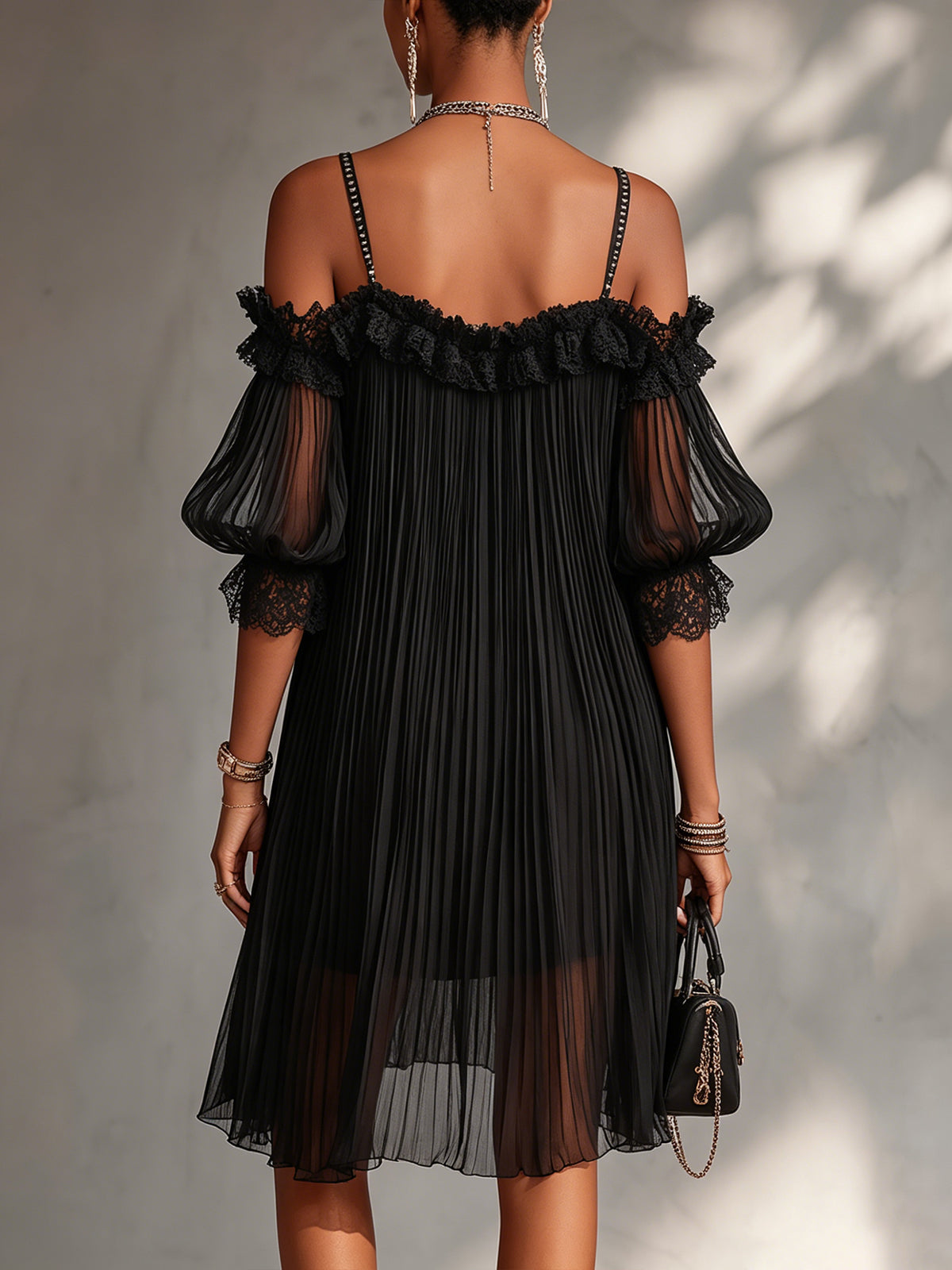 Black off-shoulder lace dress with open back, lace trim, and pleated tulle skirt