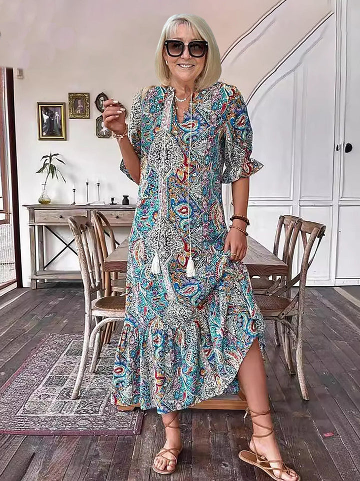 Blue patterned Boho Grace dress with tiered skirt and tassel-tie neckline