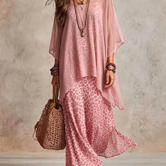 Pink bohemian maxi dress with pink leopard print skirt, sheer cape sleeves, tiered hem