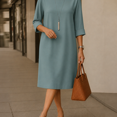 Dusty teal midi dress with round neckline and 3/4 sleeves, relaxed straight fit