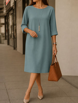 Dusty teal midi dress with round neckline and 3/4 sleeves, relaxed straight fit