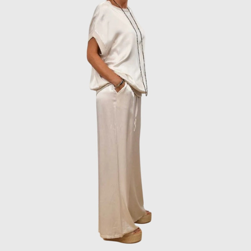 White satin two-piece set with short-sleeve top and drawstring wide-leg pants