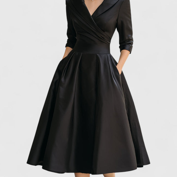 Black midi wrap dress with V-neck, 3/4 sleeves, gathered A-line skirt.