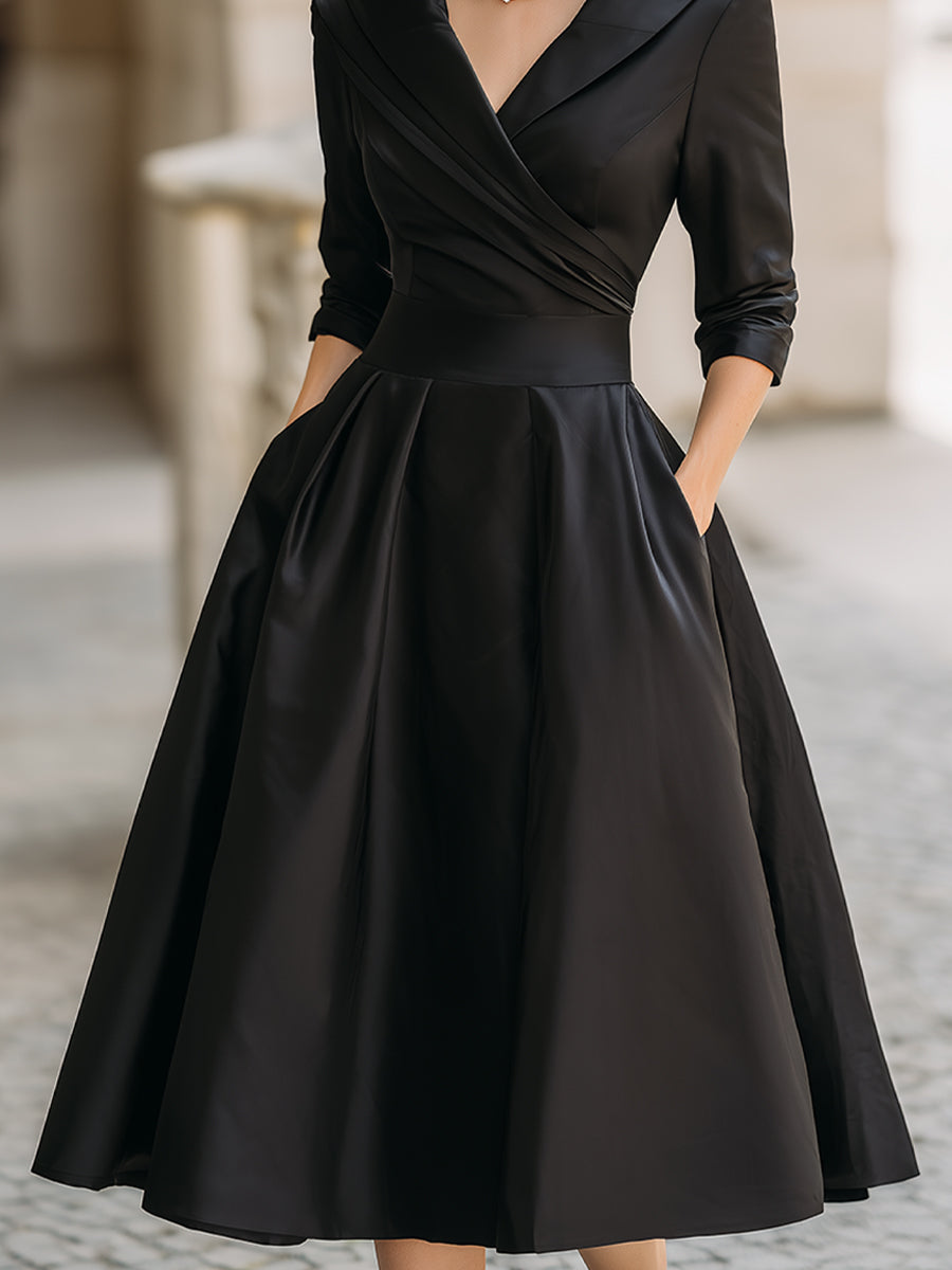 Black midi dress with wrap waist, gathered skirt, and 3/4 sleeves