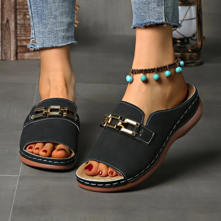 Black comfort sandals with gold buckle, open toe, stitched sole, casual slide style