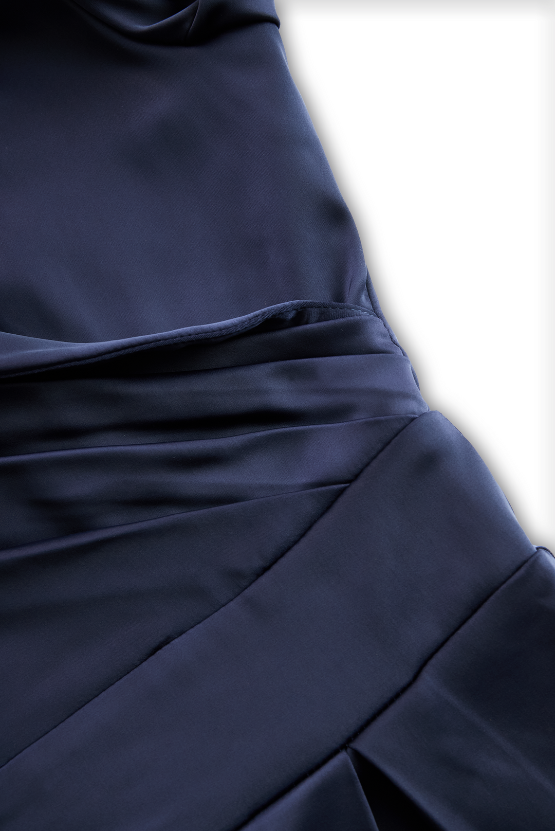 Navy midi dress fabric close-up with wrap waist seam and gathered folds