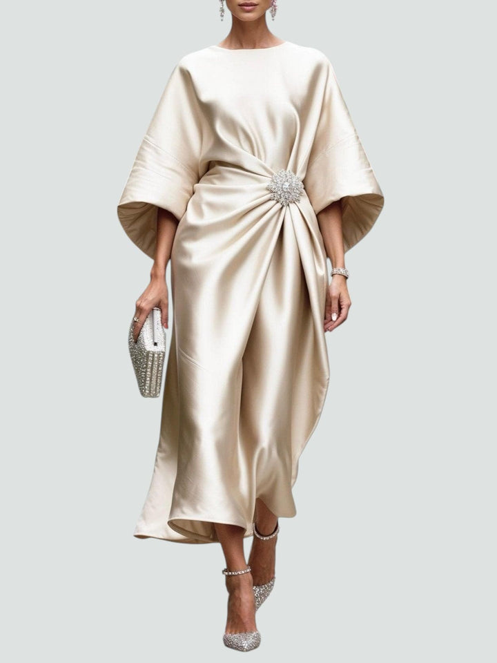 Cream satin midi dress with dolman sleeves and jeweled waist brooch