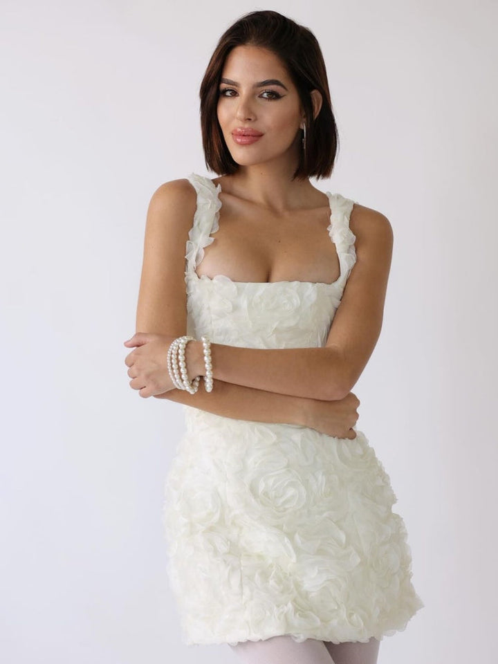 White corset mini dress with thick shoulder straps and ruffle-floral texture