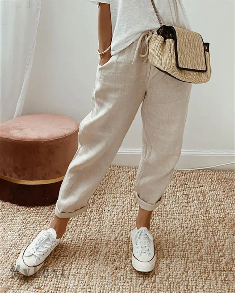 Beige casual pants with drawstring waist and cuffed ankle hem.