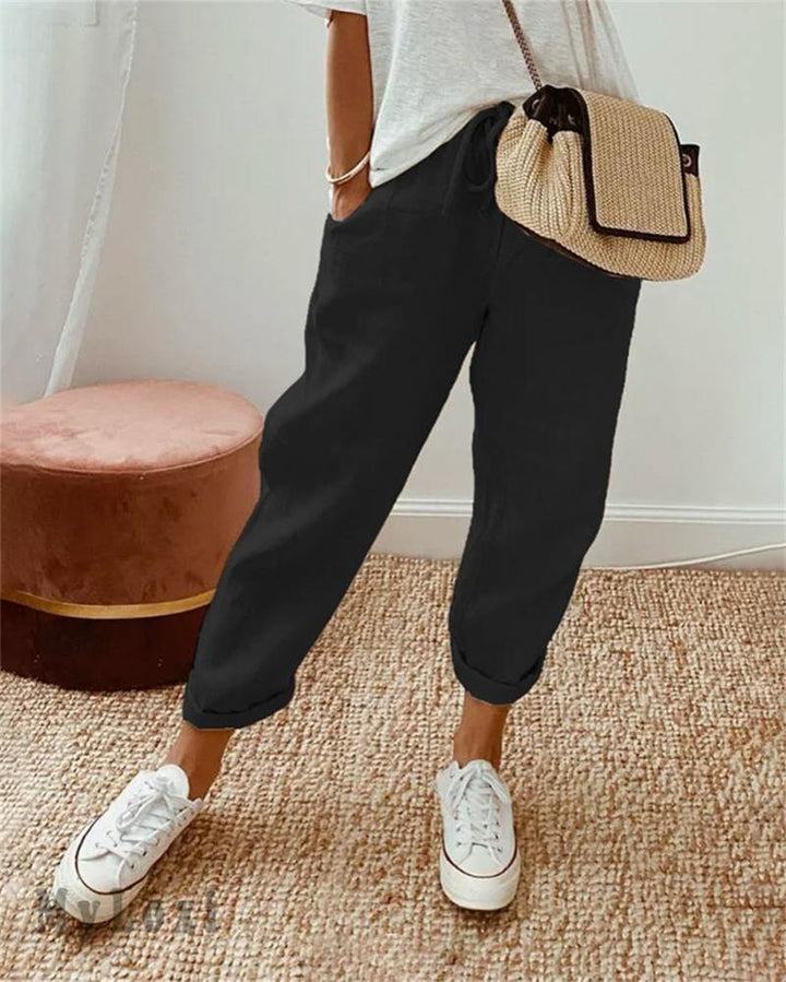 Black casual pants with drawstring waist and cuffed ankle hem.
