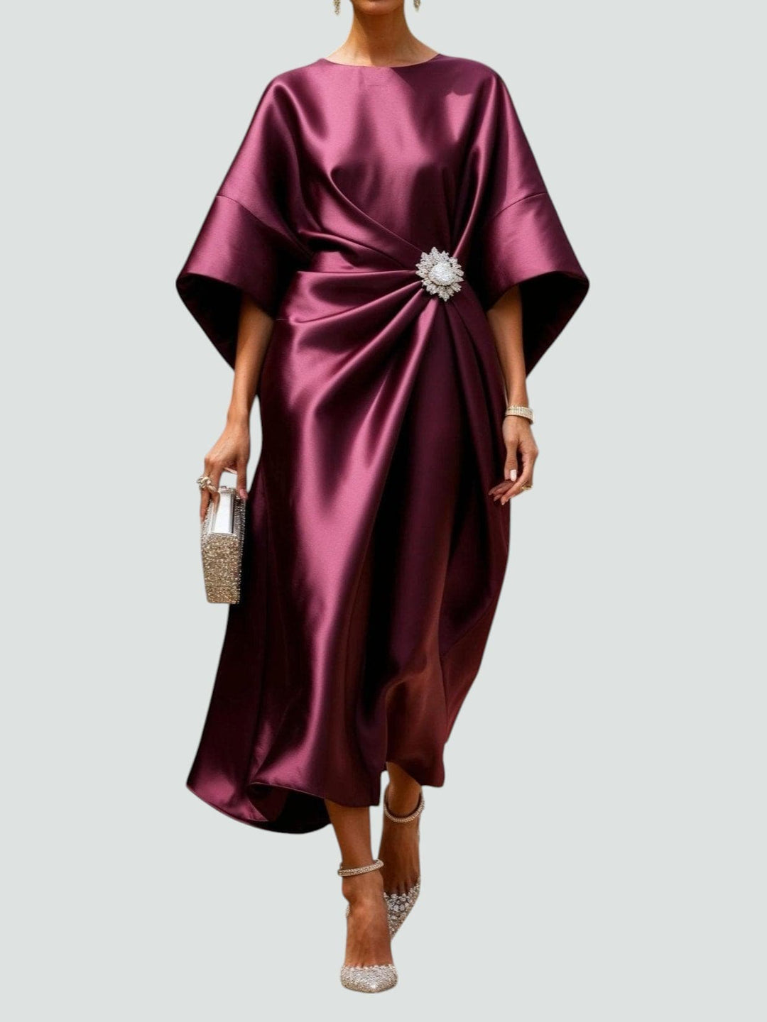 Burgundy satin midi dress with dolman sleeves and jeweled waist brooch