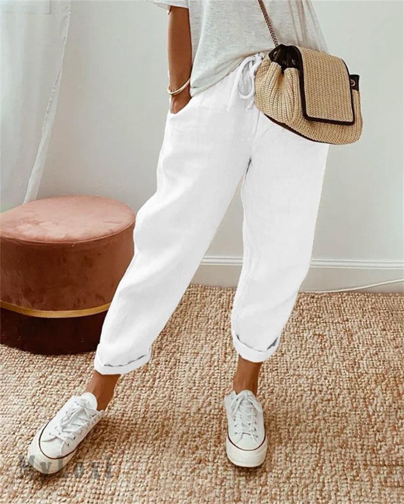 White casual pants with drawstring waist and cuffed ankle hem.