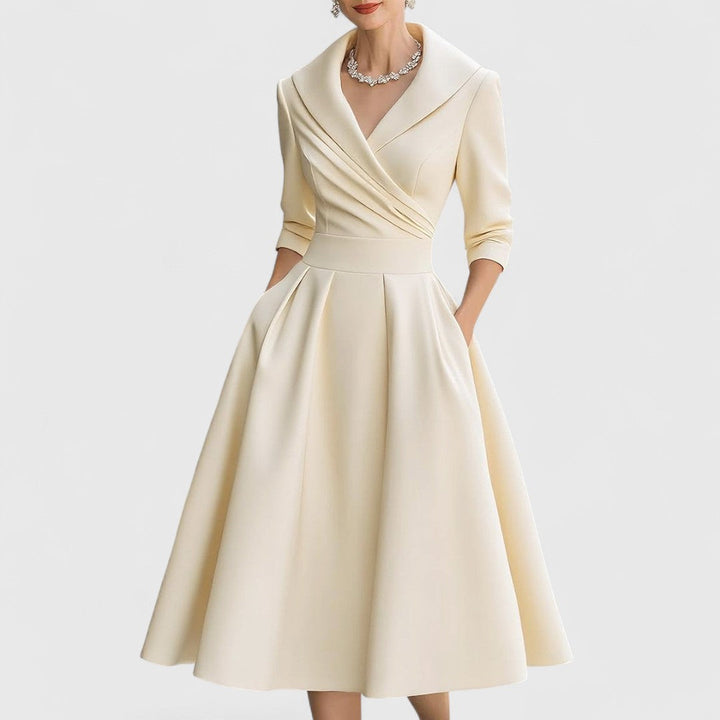 Beige midi wrap dress with V-neck, 3/4 sleeves, pleated full skirt.