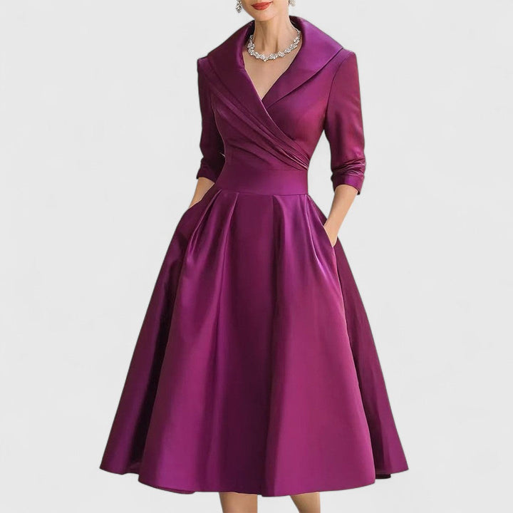 Purple midi wrap dress with V-neck, 3/4 sleeves, pleated full skirt.