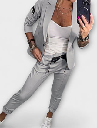 Gray blazer and pants set with white camisole top, tailored fit, 3/4 sleeves.