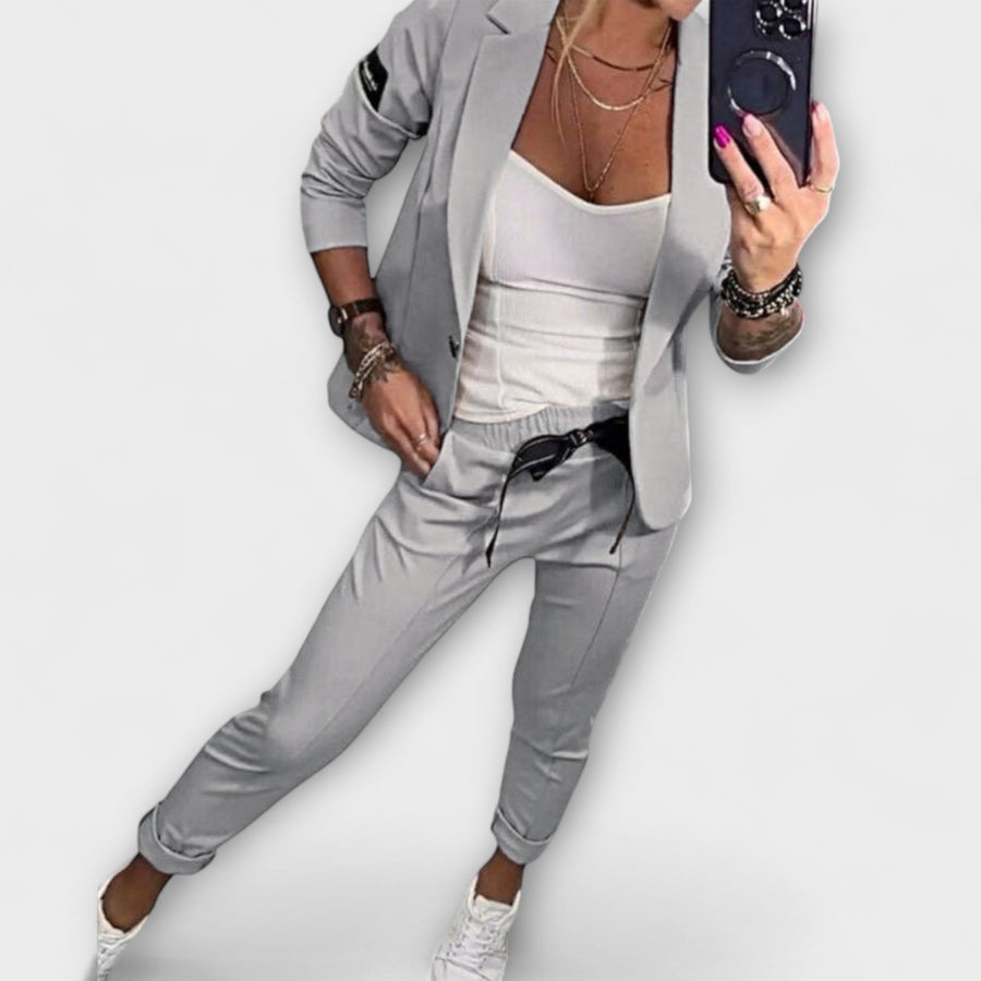 Gray blazer and pants set with white camisole top, tailored fit, 3/4 sleeves.