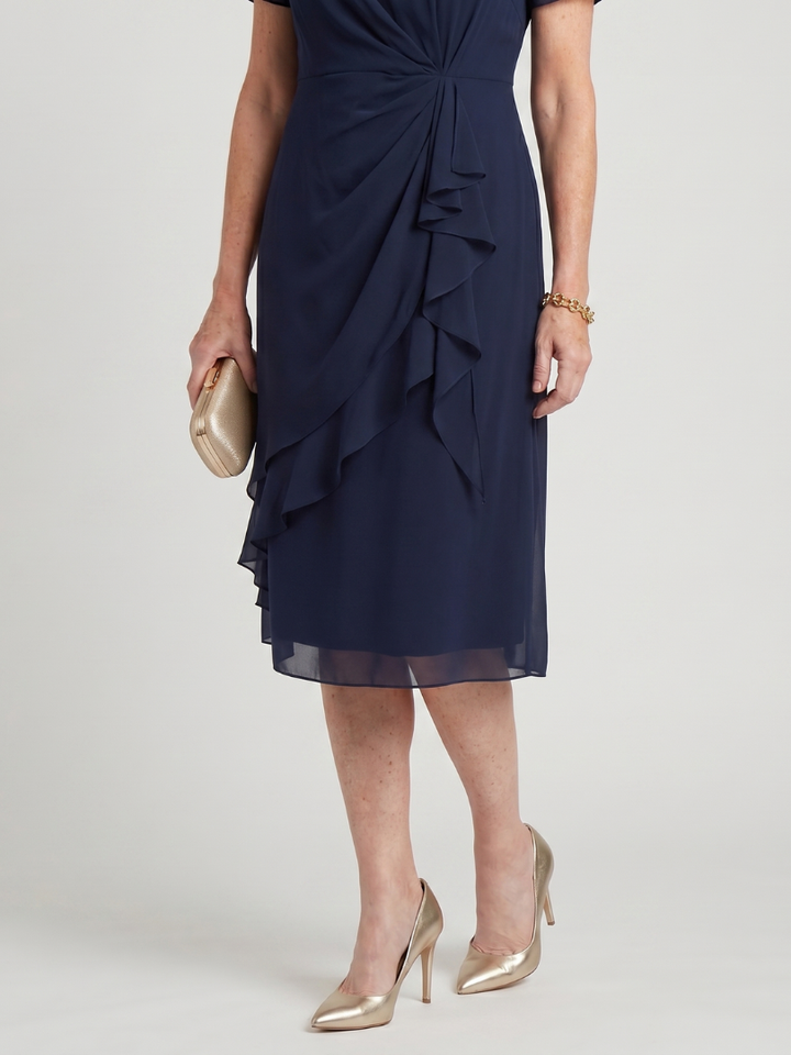 Navy midi dress close-up of layered ruffle front and asymmetrical drape hem