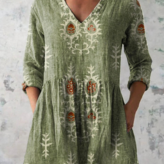 Green long-sleeve V-neck embroidered blouse with gathered waist and folk floral panels