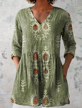 Green long-sleeve V-neck embroidered blouse with gathered waist and folk floral panels