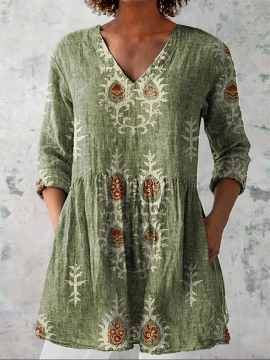 Green long-sleeve V-neck embroidered blouse with gathered waist and folk floral panels