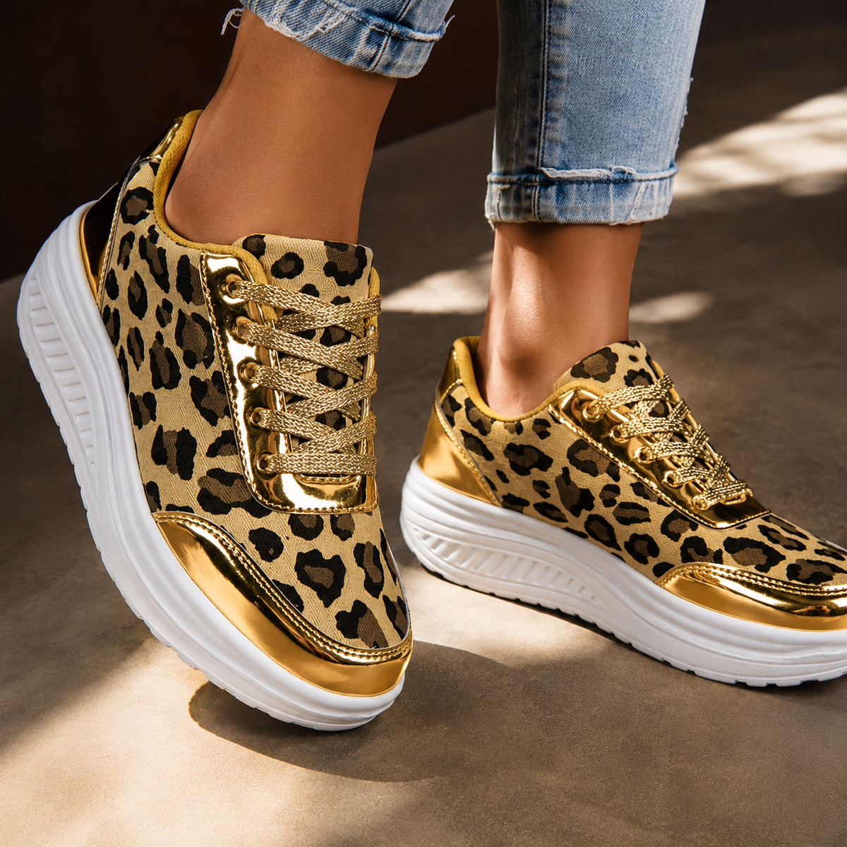 Leopard print platform sneakers on feet with gold laces and white ridged sole