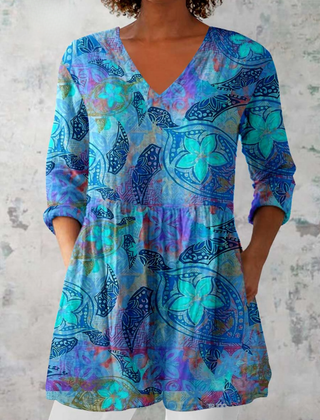 Blue V-neck long blouse with three-quarter sleeves, multicolor abstract pattern.