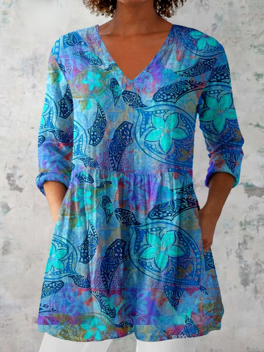 Blue V-neck long blouse with three-quarter sleeves, multicolor abstract pattern.