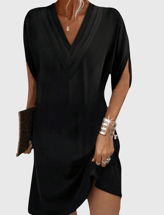 Black draped V-neck dress with short sleeves and wrap-like crossover front