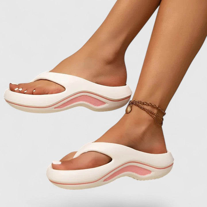 Comfort slide sandals in white with pink-toned wave sole detailing