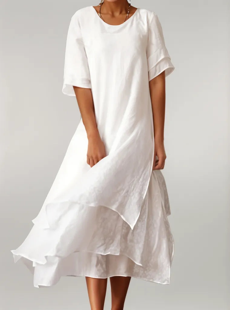 White cotton long dress with short sleeves, round neck, and layered ruffle hem