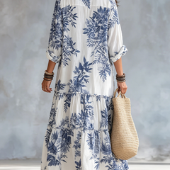 Back view of blue floral tiered maxi dress, button-front placket, 3/4 sleeves