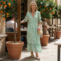 Green floral tiered midi dress with short sleeves and relaxed V-neckline