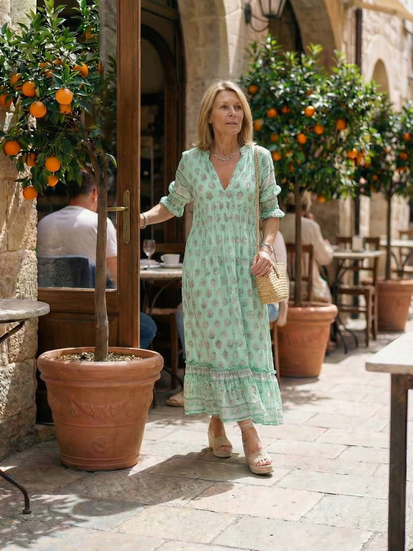 Green floral tiered midi dress with short sleeves and relaxed V-neckline