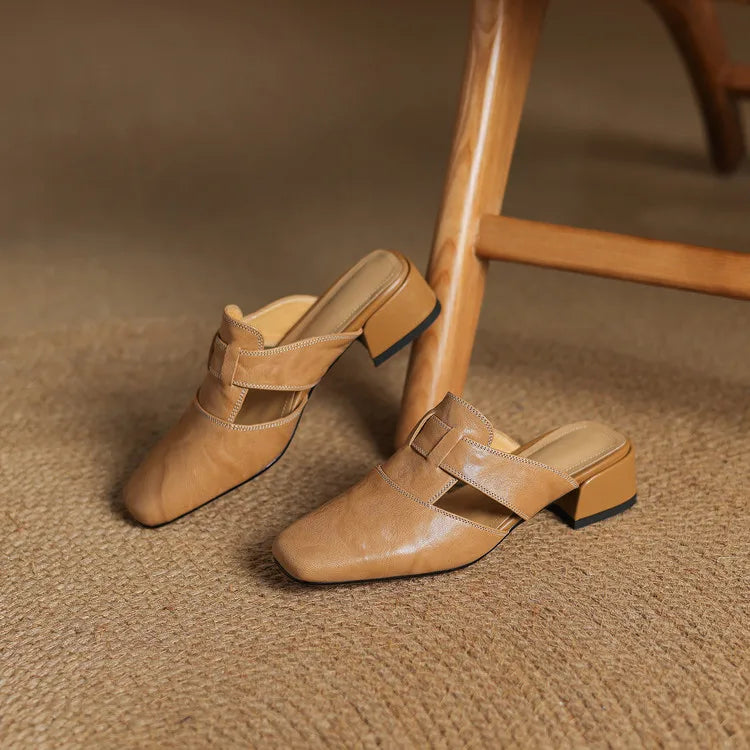 Apricot leather mules on textured surface; crossover strap and block heel shown