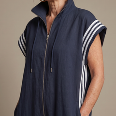 Navy blue zip jumpsuit with stand collar, drawstring hood, and white striped sleeves