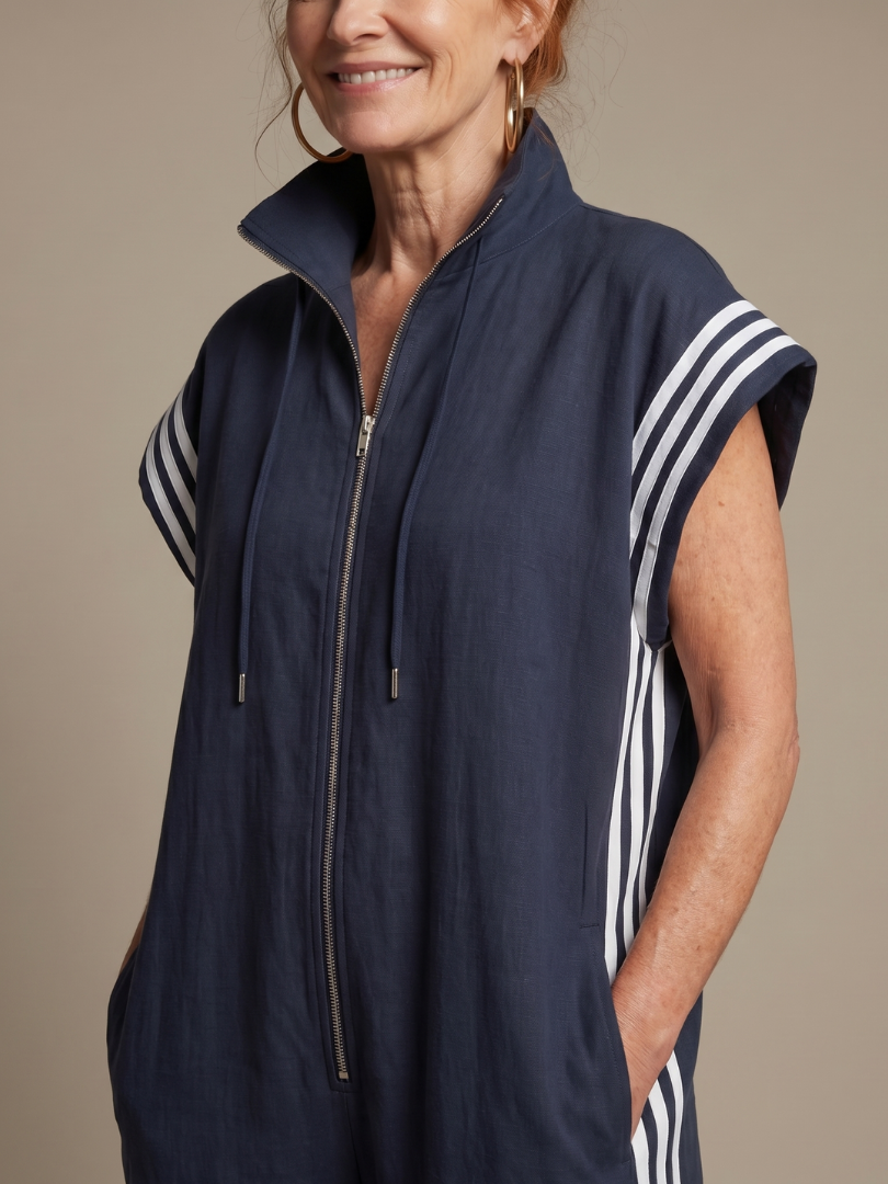 Navy blue zip jumpsuit with stand collar, drawstring hood, and white striped sleeves