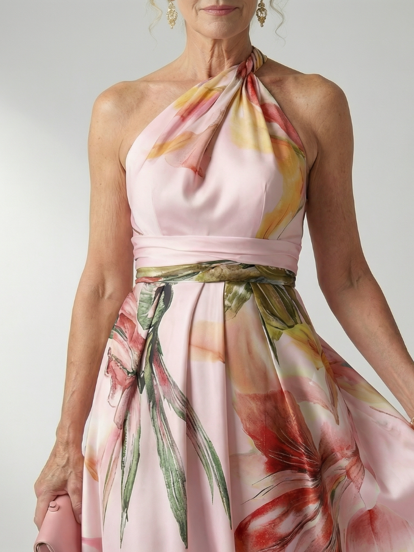 Floral halter maxi dress close-up; pale pink satin with multicolor leaf and flower print