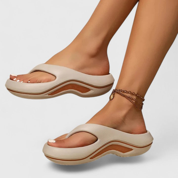 Comfort slide sandals in light beige with brown wave sole detailing