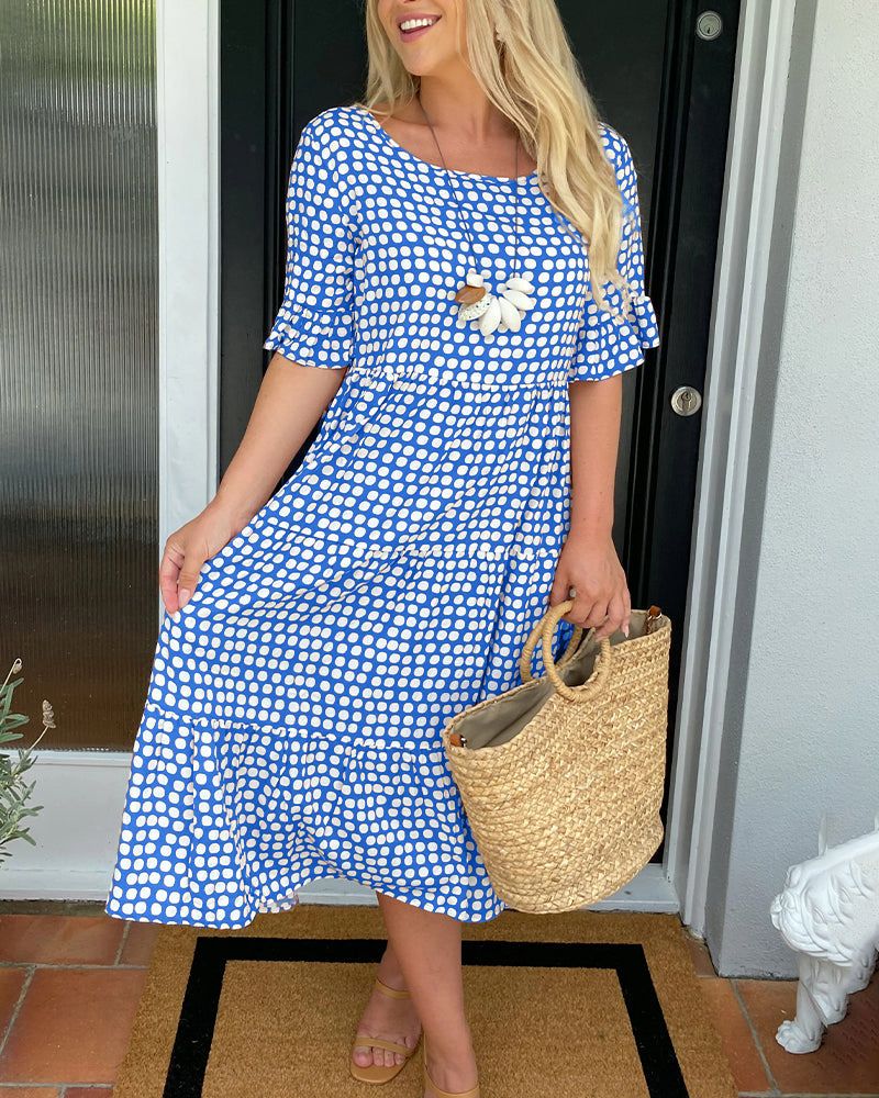 Blue patterned summer dress with short sleeves and white daisy applique at chest